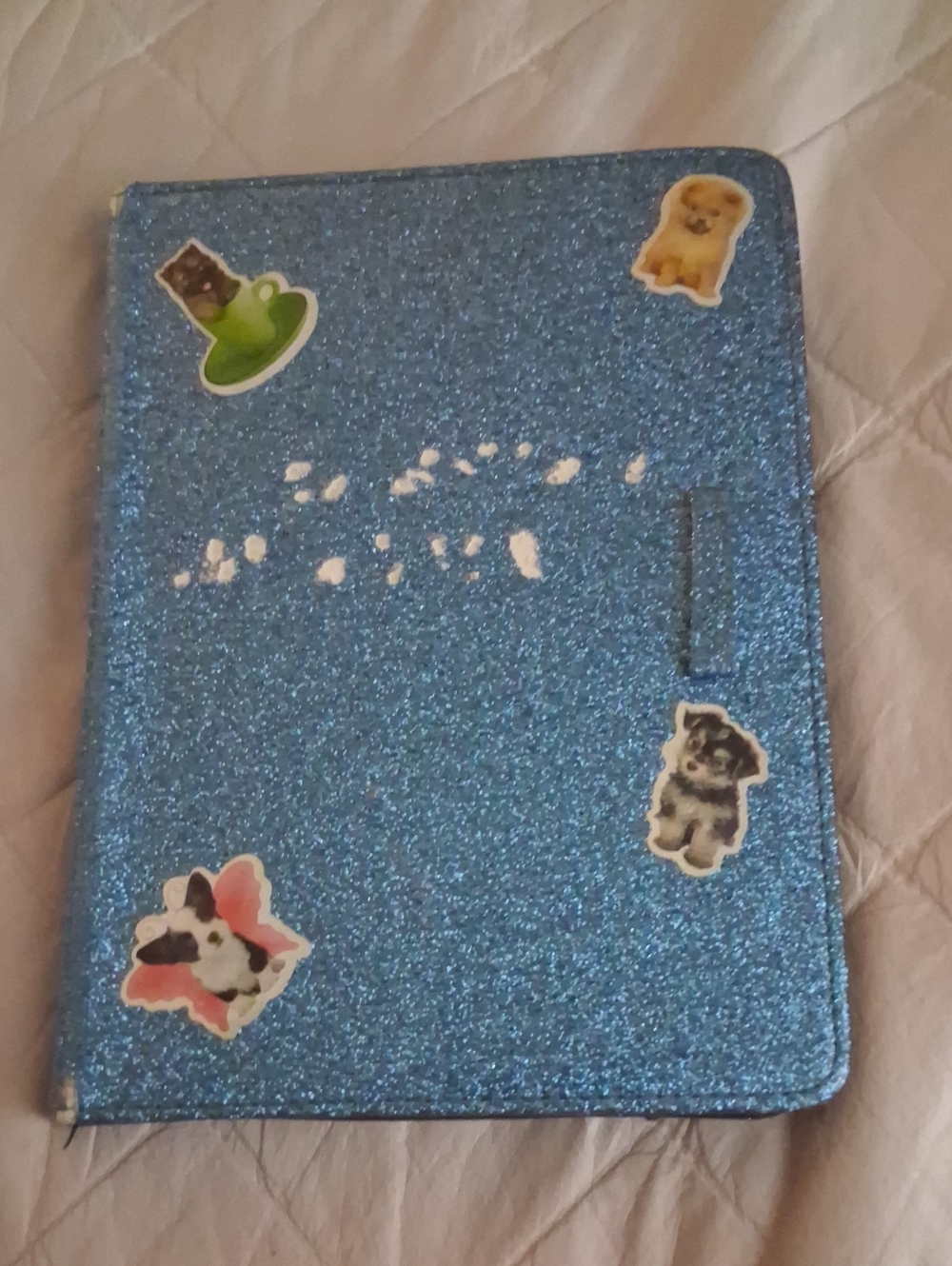 Amazon Kindle with blue case with stickers on